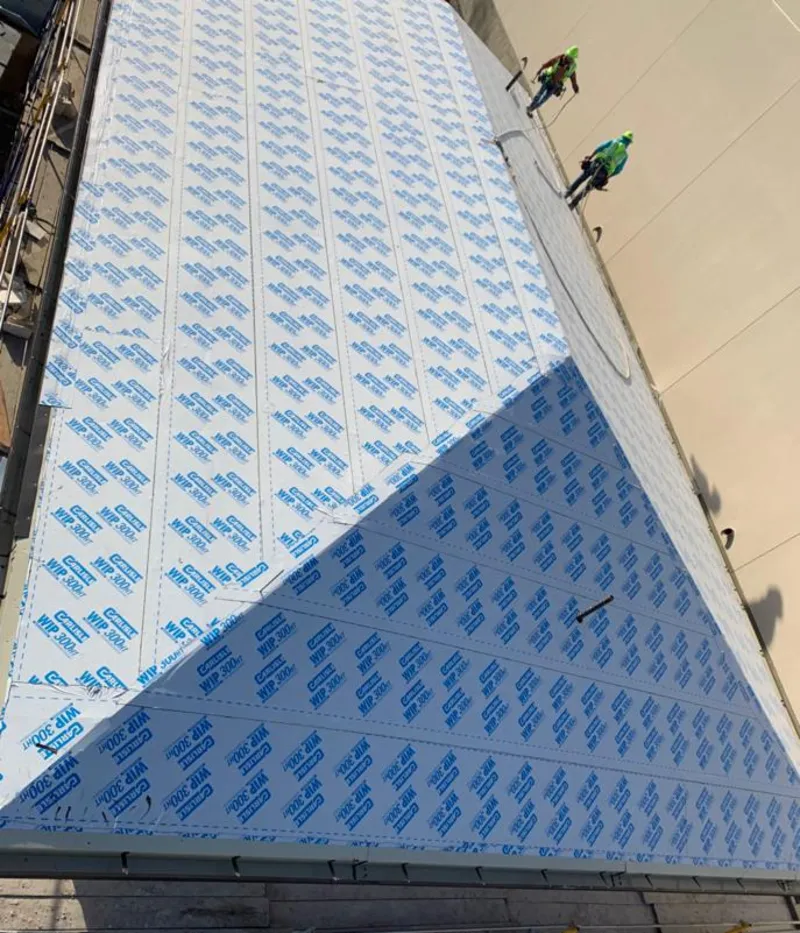 Professional roofers installing underlayment on a metal roof in Del Aire